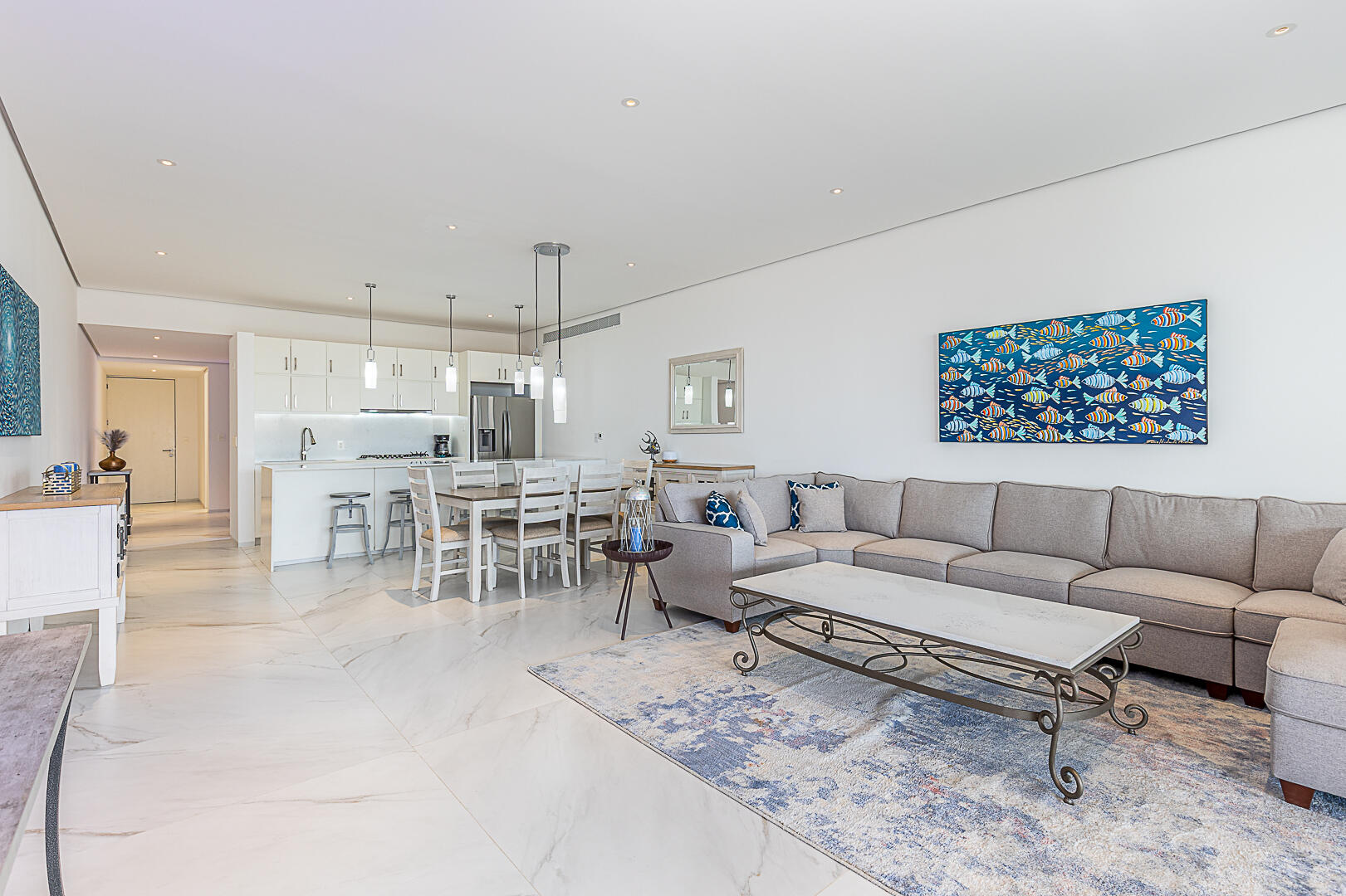 Los Cabos Cora One of the lowest-priced furnished residences currently available in Cora, this 2024-built condo is move-in ready and located within Club Campestre in San José del Cabo. The floor plan offers 3 bedrooms and 3.5 baths with approximately 1,841 sq ft of interior living space. Bright, modern interiors feature large-format tile flooring, an open-concept kitchen with island seating, and expansive sliding glass doors that connect seamlessly to oversized private decks. The interior design emphasizes clean lines, neutral finishes, and a cohesive open layout that connects the kitchen, dining, and living areas into a single, light-filled space. The kitchen is centered around a large island with quartz-style surfaces, modern cabinetry, and pendant lighting, opening directly to the main living area for easy entertaining. Floor-to-ceiling sliding glass doors extend the living space outdoors, creating a strong indoor-outdoor connection and allowing natural light to flow throughout the residence.Living and dining areas are furnished with contemporary pieces scaled appropriately for the space, complementing the modern architectural style seen throughout the development. Bedrooms are well-proportioned and designed for privacy, while bathrooms feature glass-enclosed showers and streamlined finishes consistent with the home's overall aesthetic. Privacy blinds, LED televisions with integrated switching, and thoughtfully placed lighting add functionality while maintaining a clean visual profile.Outdoor living areas are a standout feature, with expansive decks and patios offering generous space for seating, dining, and relaxation while overlooking the community's architectural landscaping and surrounding natural terrain.. Two covered on-property parking spaces include electricity and water connections suitable for electric vehicle charging or vehicle washing, and a private 10x10x14 storage locker with electricity provides secure owner storage.Cora is a gated, master-planned community within Campestre San José, featuring contemporary architecture and resort-style amenities visible throughout the property. Community offerings include a large swimming pool with integrated lounging areas, a hot tub, fitness center, indoor children's play area, and an enclosed dog park, all supported by 24/7 security. The Campestre San José golf course is approximately 0.5 miles away, and the private beach club on the Sea of Cortez is roughly 2.5 miles from the residence, subject to membership terms.Dining, recreation, and services are easily accessible, with Flora Farms approximately 2.8 miles away, Acre Restaurant about 3.0 miles, and the Historic Art District of downtown San José del Cabo roughly 4.5 miles from the property. Beachfront dining along the Tourist Corridor, including venues such as Veleros Beach Club and 7 Seas Grille & Seafood, is approximately 6.5 miles away, while Los Cabos International Airport is about 10.5 miles from the residence.Offered fully furnished and... for sale