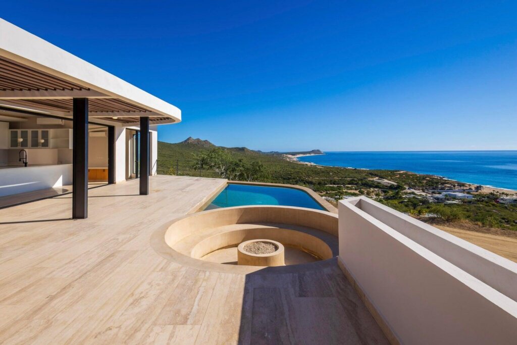 Los Cabos Los Valles Sophisticated and solidly built, this 5,588 sq.ft. estate in Club Campestre offers luxury living with exceptional construction quality rarely found in Los Cabos. Residents enjoy exclusive access to a private beach club and world-class golf course, all just minutes from San Jose vibrant dining and culture. The home features 4 ensuite bedrooms, a 3-stop elevator, and a Generac backup system. Entertain in style with a chef's kitchen, wine room with Tzalam wood cabinetry, and an outdoor BBQ area with fire pit. Relax by the heated pool or on the Jacuzzi terrace with partial ocean – La Cañada, San Jose del Cabo, BS